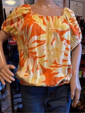 SINGLE THREAD Women’s Elastic-Hem Floral Peasant Top in Orange and Yellow.